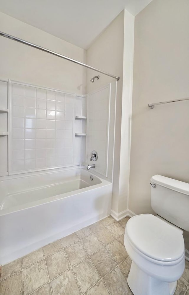 bathroom with toilet, baseboards, and bathing tub / shower combination