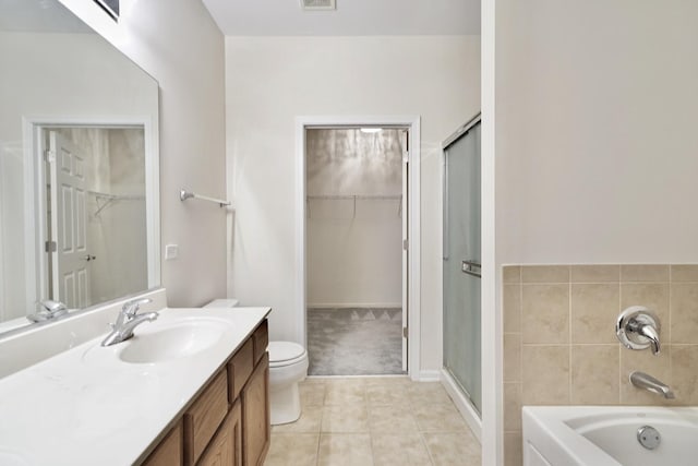 full bath with a shower stall, a walk in closet, a bath, and vanity