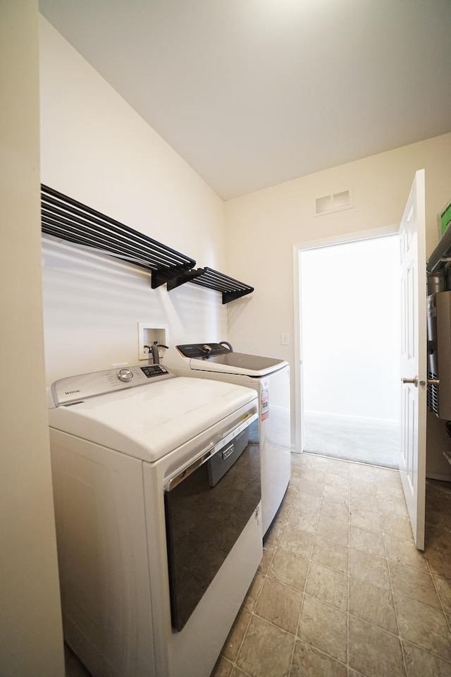 laundry area featuring laundry area, visible vents, and independent washer and dryer