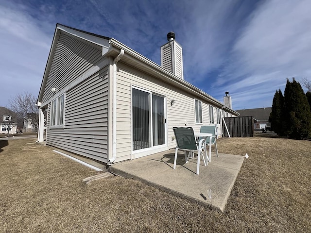 back of property featuring a patio area and a chimney