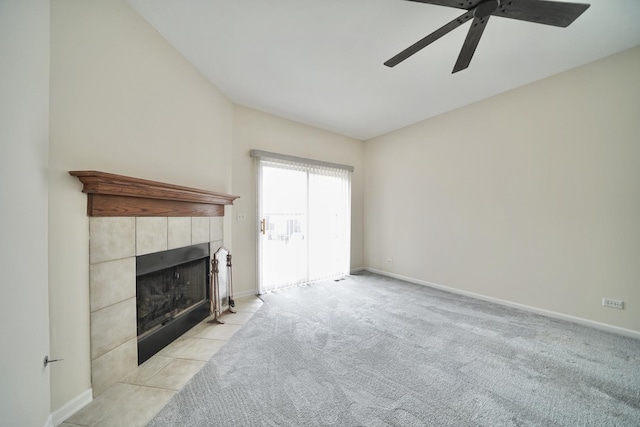 unfurnished living room featuring light carpet, baseboards, a ceiling fan, and a tile fireplace