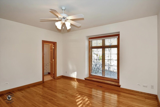 empty room with a ceiling fan, light wood-type flooring, visible vents, and baseboards