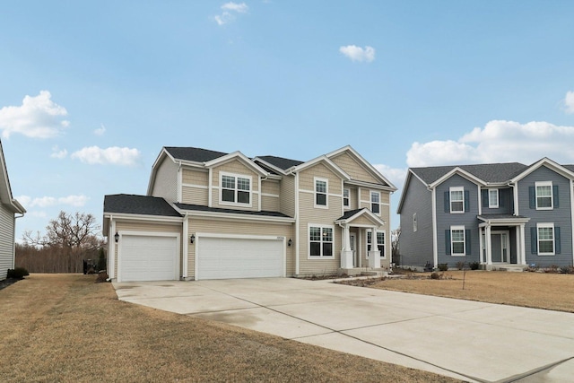 traditional-style home with a garage, driveway, and a front lawn