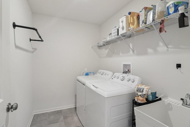 laundry room featuring laundry area, a sink, washer and clothes dryer, and baseboards