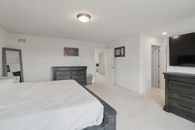 bedroom featuring light carpet and visible vents