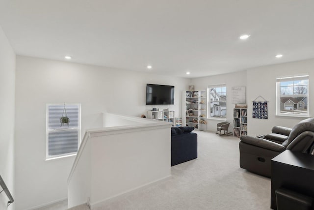 living area featuring light carpet and recessed lighting