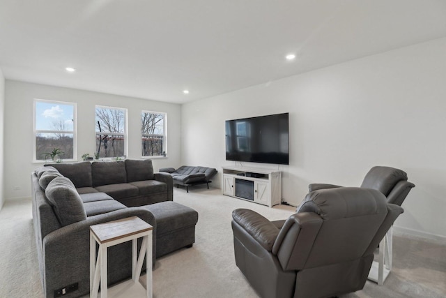 living room with recessed lighting, light colored carpet, and baseboards