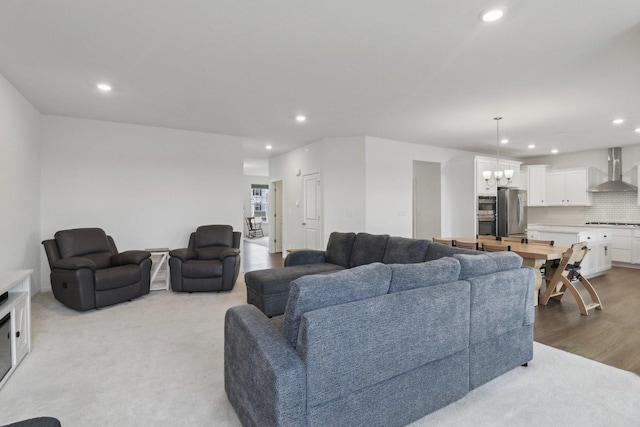 living room with an inviting chandelier, wood finished floors, and recessed lighting