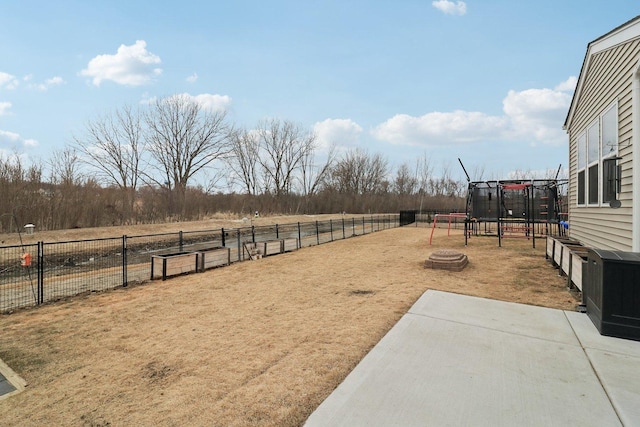 view of yard featuring an outdoor fire pit and fence