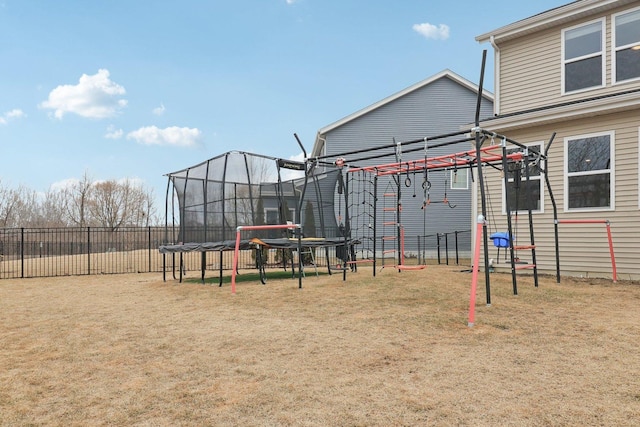 exterior space with a trampoline, fence, a lawn, and a pergola