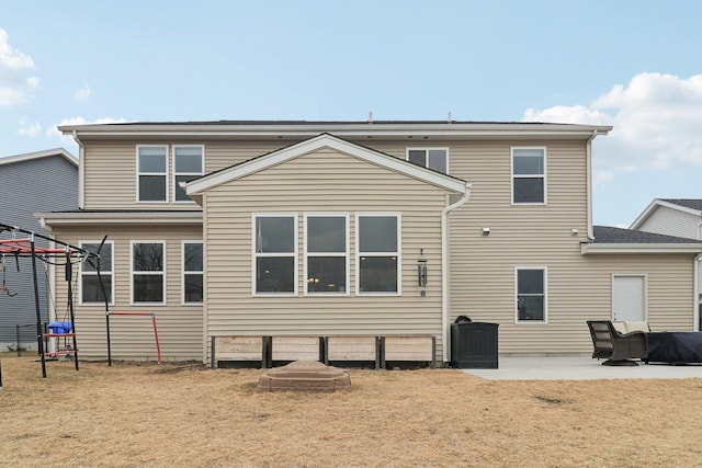 back of property featuring a yard and a patio area