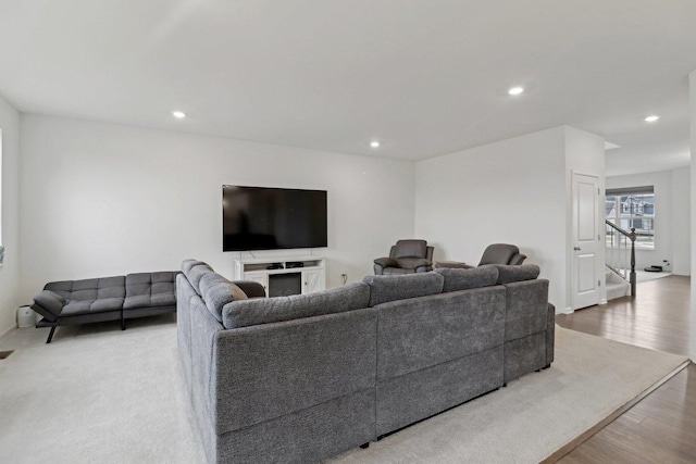 living room featuring stairs, wood finished floors, and recessed lighting