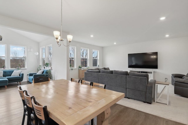 dining room with a notable chandelier, wood finished floors, a wealth of natural light, and recessed lighting