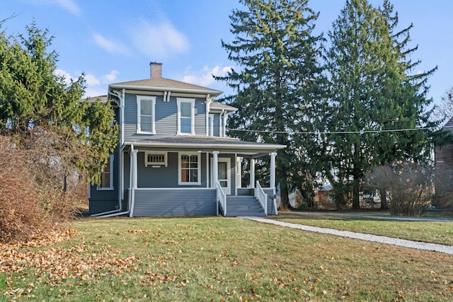 view of front of house featuring a porch, a front lawn, and a chimney