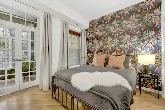 bedroom with french doors and wood finished floors