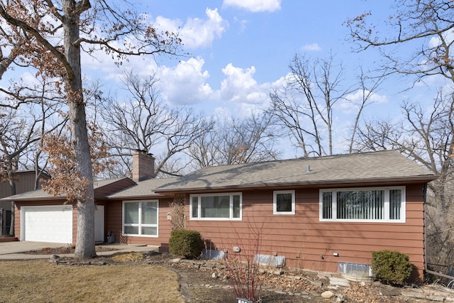 single story home with a garage, driveway, a chimney, and roof with shingles