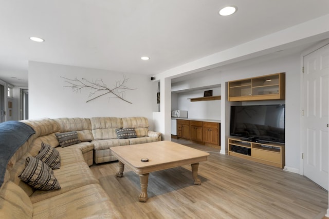 living area with recessed lighting and light wood-style floors