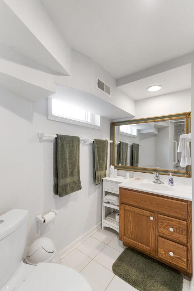 bathroom featuring visible vents, toilet, vanity, tile patterned flooring, and baseboards