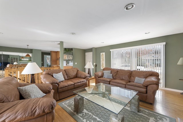 living room with light wood-style flooring, baseboards, and recessed lighting