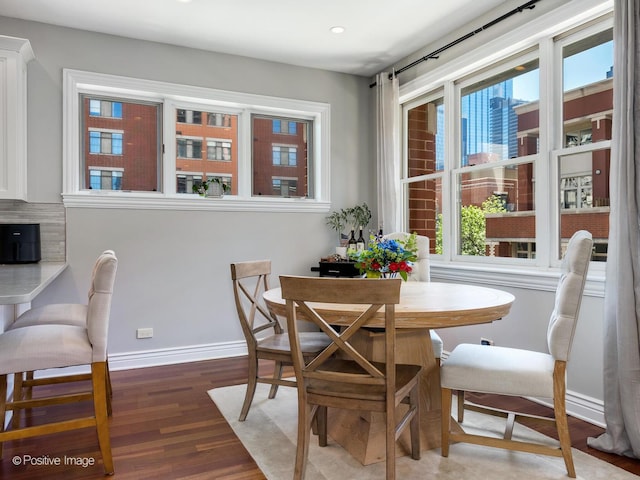 dining room with recessed lighting, baseboards, and wood finished floors