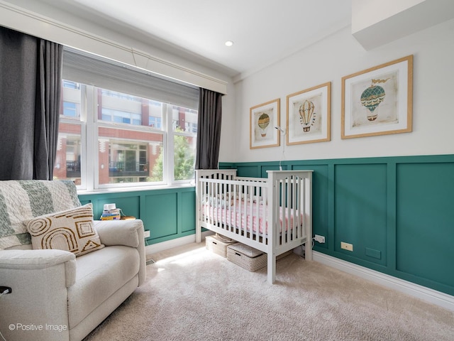 bedroom featuring recessed lighting, carpet, and a decorative wall