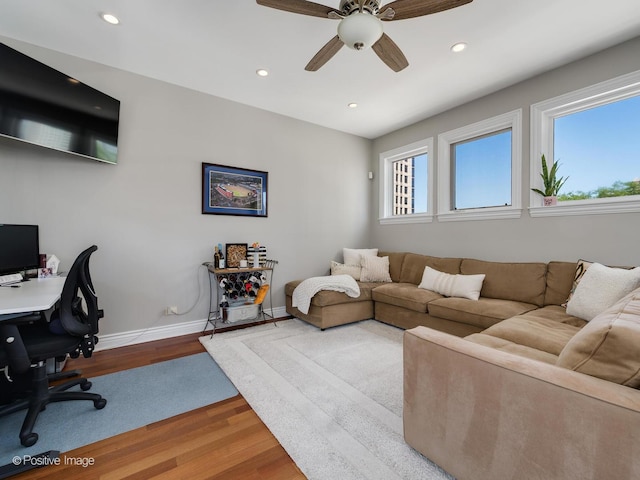 living area with recessed lighting, wood finished floors, a ceiling fan, and baseboards