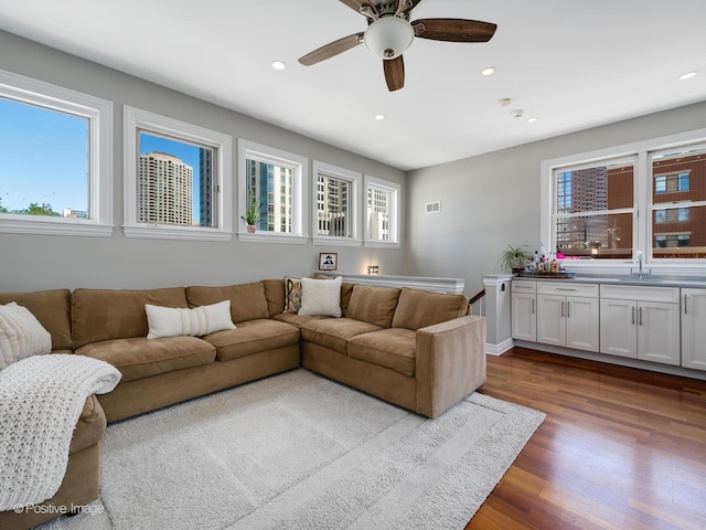 living area with visible vents, dark wood finished floors, a ceiling fan, and recessed lighting