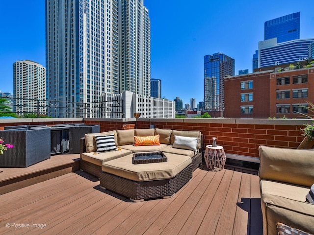 wooden terrace featuring an outdoor hangout area and a city view