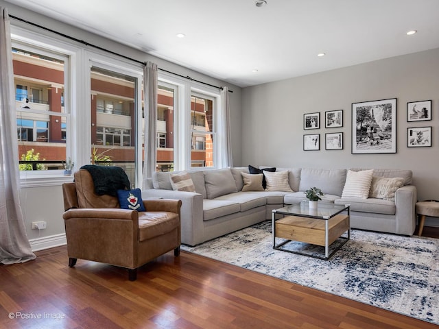 living room with recessed lighting, baseboards, and wood finished floors