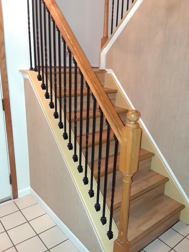 stairs with baseboards and tile patterned flooring
