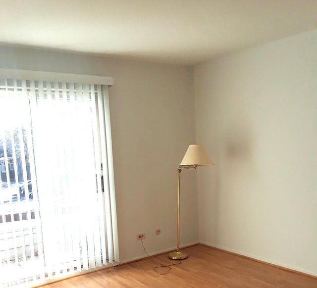 unfurnished room with light wood finished floors