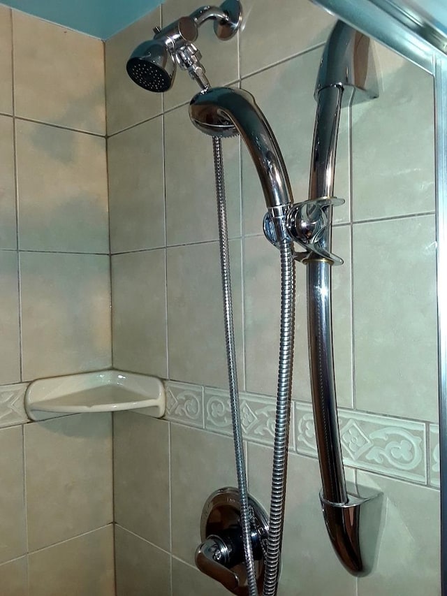 details with tiled shower and a sink