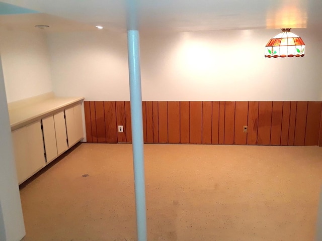 basement with wood walls and wainscoting