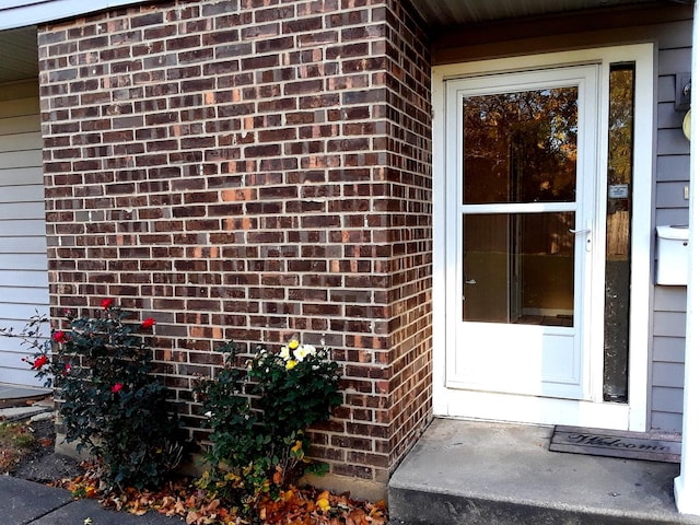 property entrance with brick siding