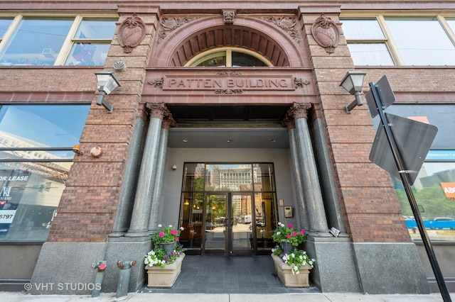 view of exterior entry with french doors and brick siding