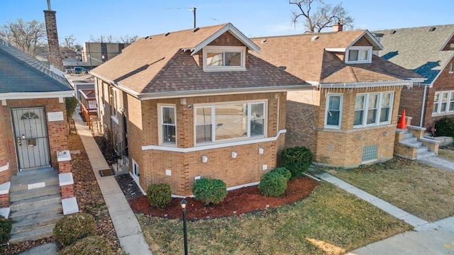 bungalow with brick siding and roof with shingles