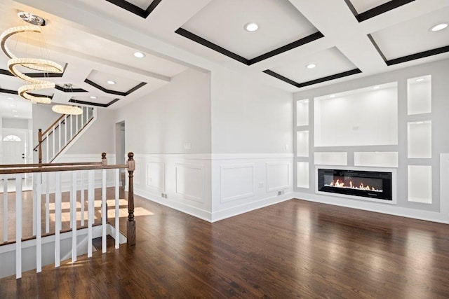 interior space with recessed lighting, coffered ceiling, a decorative wall, and wood finished floors