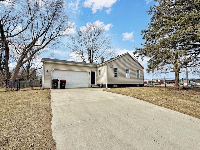 ranch-style house with concrete driveway, fence, and an attached garage