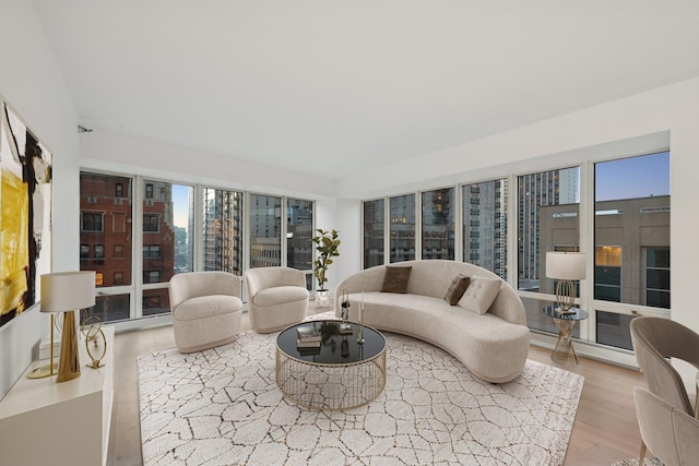 living area with a view of city and wood finished floors