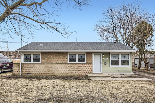 ranch-style home with crawl space, a shingled roof, and brick siding