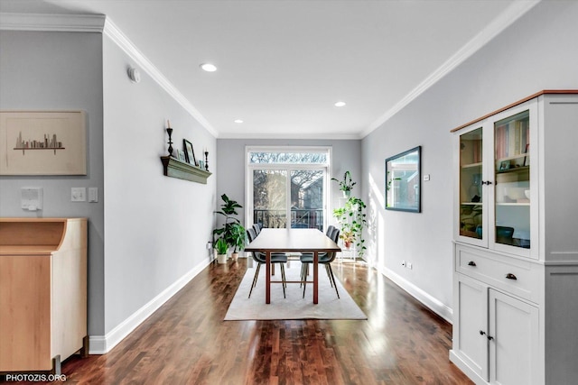 dining space featuring washer / dryer, baseboards, dark wood finished floors, and crown molding