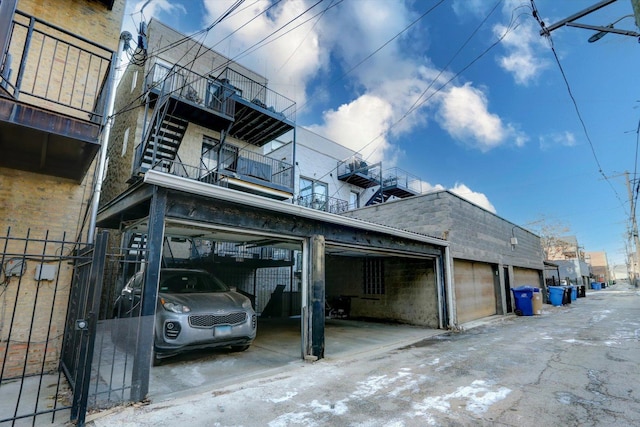 exterior space with fence and community garages