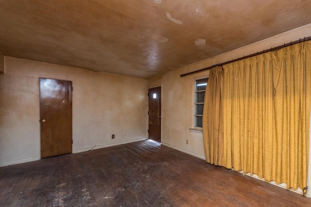 spare room with wood-type flooring