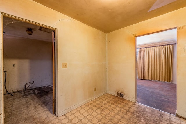 unfurnished room featuring visible vents and light floors