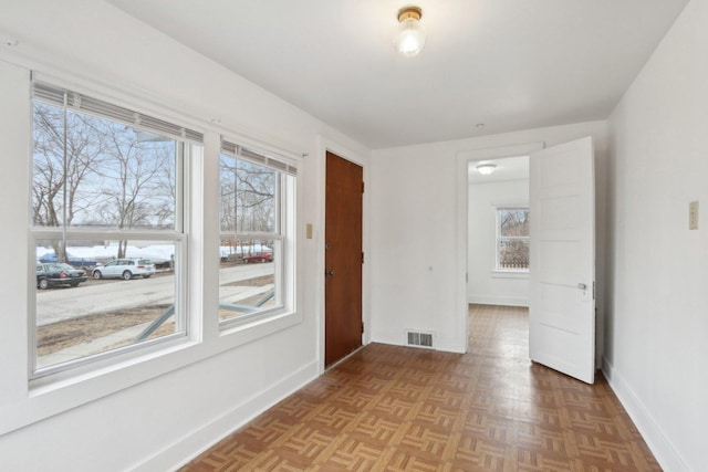 spare room with visible vents and baseboards