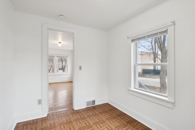 empty room with visible vents and baseboards