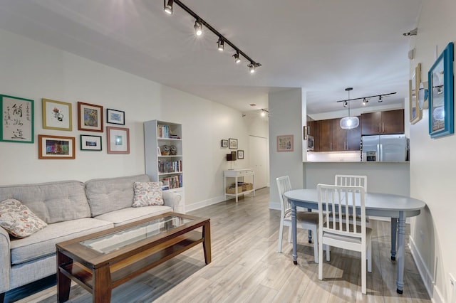 living room featuring light wood-style flooring and baseboards