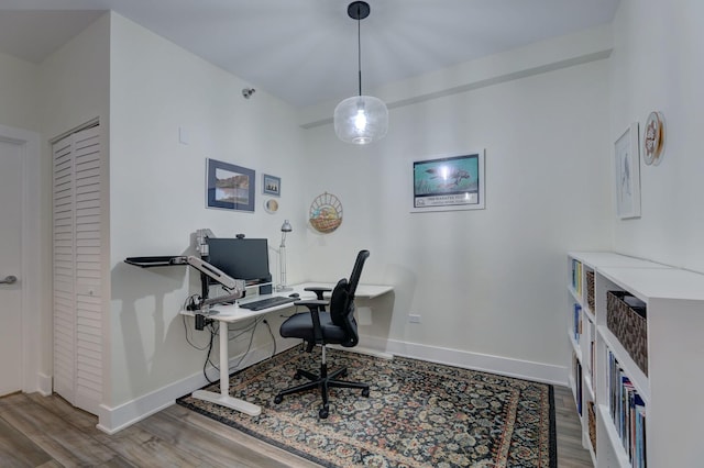 home office featuring wood finished floors and baseboards