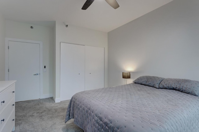 bedroom with ceiling fan, a closet, and light colored carpet