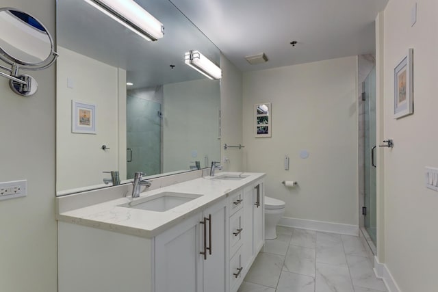 bathroom featuring marble finish floor, double vanity, a sink, and a shower stall